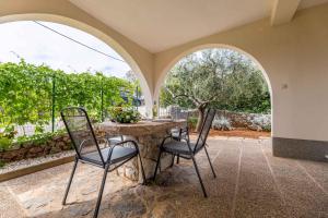 a dining room with a table and two chairs at Apartment in Vrbnik/Insel Krk 36871 in Vrbnik