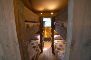 a small room with two bunk beds in it at Lodge Holidays - Camping Podere Sei Poorte in Genga