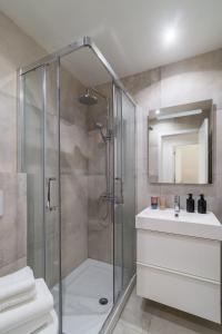 a bathroom with a shower and a sink at Casa Boma Lisboa - Design Apartment with Private Vegetal Terrace - Lapa VII in Lisbon