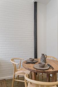 a wooden table with chairs and a table with hats on it at Casa Boma Lisboa - Design Apartment with Private Vegetal Terrace - Lapa VII in Lisbon