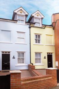 a row of white houses with yellow at Beautifully furnished 4-bed townhouse on South Cliff in Scarborough