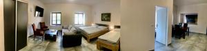 a living room with a couch and a bed in it at Penzion Sloup in Sloup
