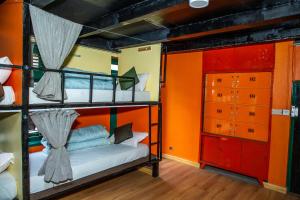 A bed or beds in a room at Trekkers Hostel