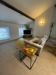 a living room with a couch and a coffee table at Flat 2 Chestergate in Macclesfield