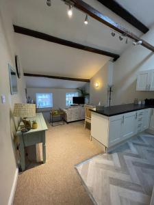 a kitchen and living room with a table and a couch at Flat 2 Chestergate in Macclesfield
