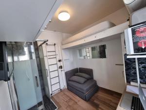 a small room with a couch in a tiny house at Amazing Studio near Parc des Expositions in Paris