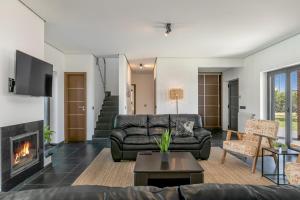 a living room with a couch and a fireplace at Casa Amizade in Aljezur