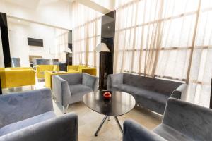 a living room with couches and a table and chairs at Prince de Paris in Casablanca