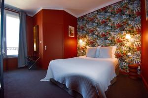 a hotel room with a bed and a wall covered in photographs at Hôtel Azur in Reims