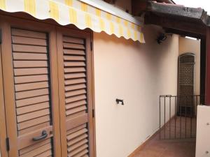 a garage door with awning on the side of a house at Cagliari Elmas Airport Beautiful Mansarda in Assemini