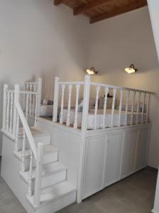 a white bunk bed with a white crib in a room at Traditional Luxury House in Kalithies