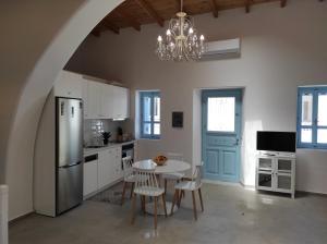 a kitchen with a table with chairs and a chandelier at Traditional Luxury House in Kalithies