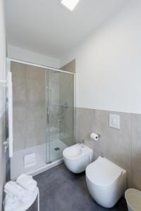 a bathroom with a shower and a toilet and a sink at Boutique Hotel Nuovo Cason in Cavallino-Treporti