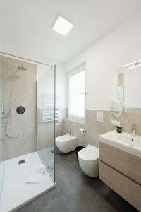 a bathroom with a toilet and a sink and a shower at Boutique Hotel Nuovo Cason in Cavallino-Treporti