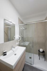 a white bathroom with a sink and a shower at Boutique Hotel Nuovo Cason in Cavallino-Treporti