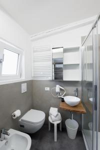 a bathroom with a toilet and a sink at Boutique Hotel Nuovo Cason in Cavallino-Treporti