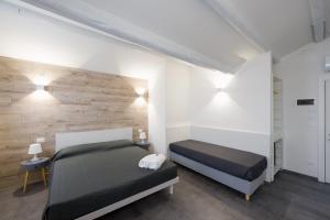 a bedroom with two beds and a wooden wall at Boutique Hotel Nuovo Cason in Cavallino-Treporti