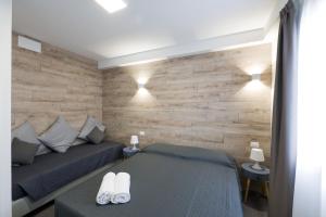 a bedroom with two beds and a wooden wall at Boutique Hotel Nuovo Cason in Cavallino-Treporti