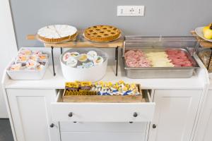 a kitchen with food on a white counter at Boutique Hotel Nuovo Cason in Cavallino-Treporti
