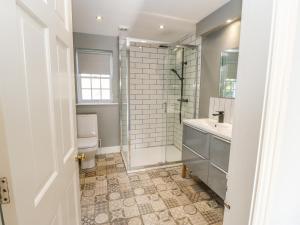 a bathroom with a shower and a toilet and a sink at Burns Cottage in Barnard Castle +84 photos