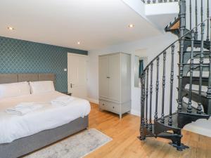 1 dormitorio con 1 cama y escalera de caracol en Burns Cottage en Barnard Castle