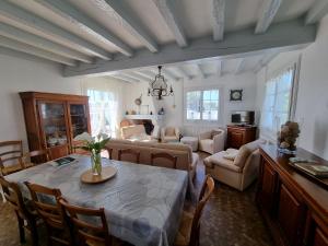 a living room with a table and chairs and a living room at Noirmoutrine in Noirmoutier-en-l'lle