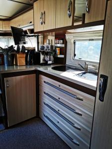 a kitchen with a sink in an rv at Hausboot Mosel in Pölich
