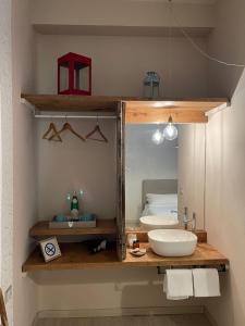 a bathroom with a sink and a mirror at Locanda Garzelli in Quercianella