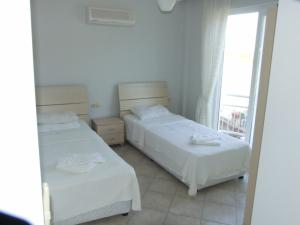 Postel nebo postele na pokoji v ubytování Sunset Beach Club