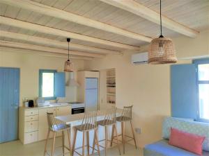 a kitchen and dining room with a table and chairs at Mosaic Suites in Drios