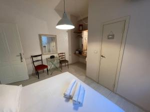 a room with a bed with blue towels on it at Locanda Garzelli in Quercianella