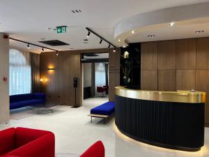 a lobby with a reception desk in a building at Hotel Milenij in Makarska