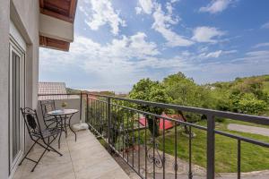 a patio with a table and chairs on a balcony at Apartments Klara in Senj