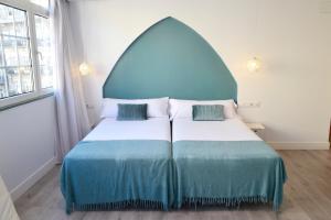 Кровать или кровати в номере Hotel Alda Puerta Del Sol