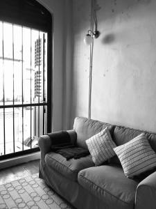 a living room with a couch and a lamp at 97 Yaowarat - Phuket Old Town in Phuket Town