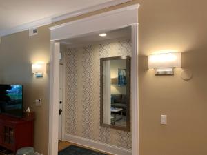 a hallway with a mirror and a television at 1F Cozy Home in Little Italy near Downtown West Loop United Center in Chicago