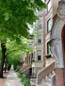 a building with a stone staircase in front of a street at 1F Cozy Home in Little Italy near Downtown West Loop United Center in Chicago