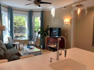 a kitchen and living room with a sink and a tv at 1F Cozy Home in Little Italy near Downtown West Loop United Center in Chicago