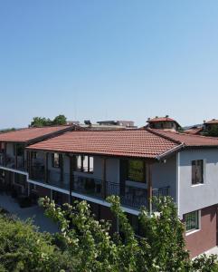 an apartment building with a red tile roof at Studio 8 Arapya in Tsarevo