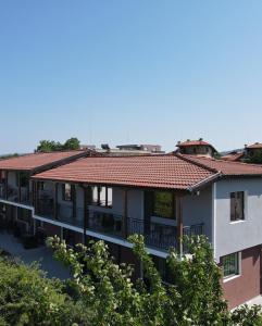 an apartment building with a red tile roof at Studio 8 Arapya in Tsarevo +8 photos