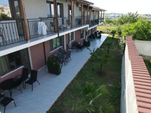a balcony of a building with chairs and tables at Studio 8 Arapya in Tsarevo