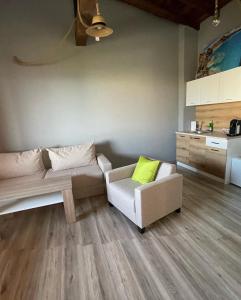 a living room with a couch and a chair at Studio 8 Arapya in Tsarevo
