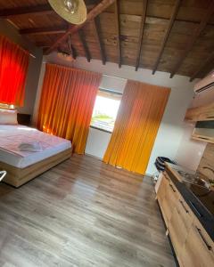 a bedroom with a bed and a window with curtains at Studio 8 Arapya in Tsarevo