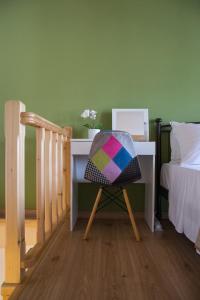 a chair sitting at a desk next to a bed at Stonehouse with wonderful seaview in Samos