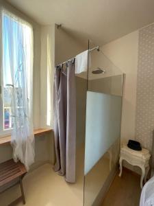 a bathroom with a shower with a glass door at Locanda Garzelli in Quercianella