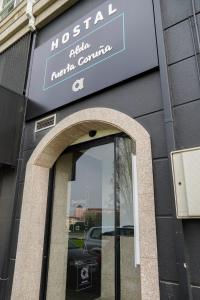 a sign on the side of a building with a window at Alda Puerta Coruña in A Coruña