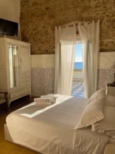 Ένα ή περισσότερα κρεβάτια σε δωμάτιο στο Locanda Garzelli