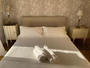 a bedroom with a bed with two towels on it at Locanda Garzelli in Quercianella
