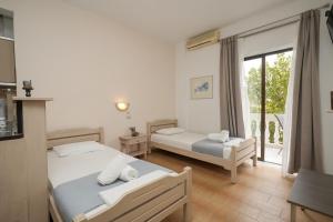 Ένα ή περισσότερα κρεβάτια σε δωμάτιο στο Haus Galini