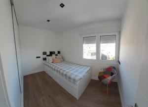 Łóżko lub łóżka w pokoju w obiekcie Piso El Acantilado